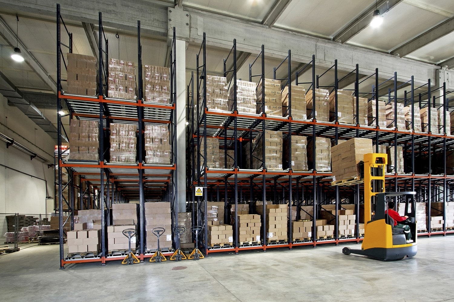 Yellow fork lifter work in big warehouse