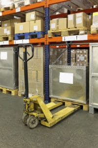 Manual pallet truck in distribution center warehouse