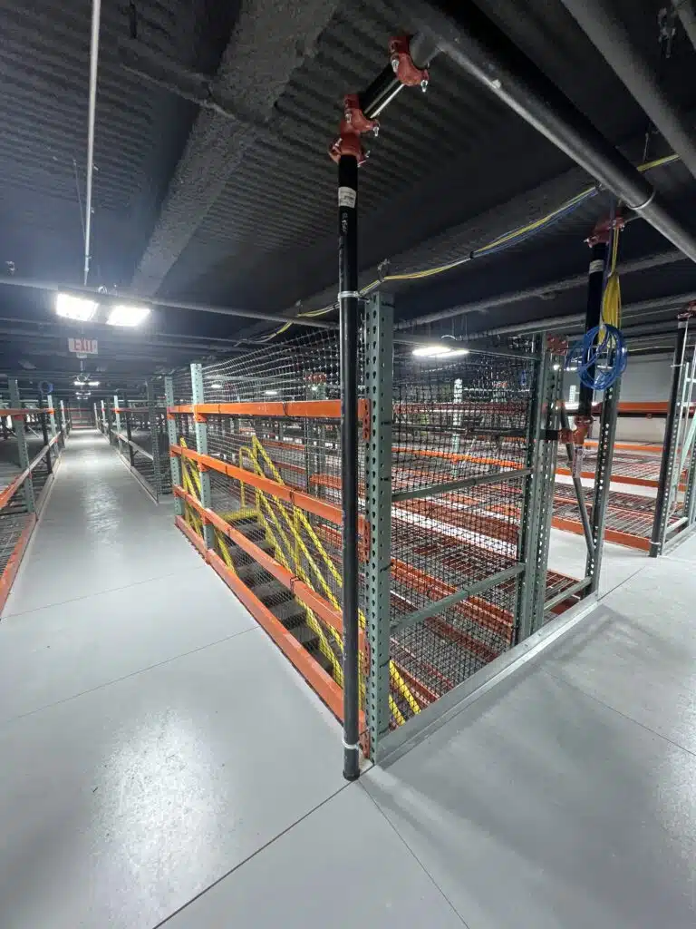 Second level of a catwalk racking with staircase in a retail backroom environment