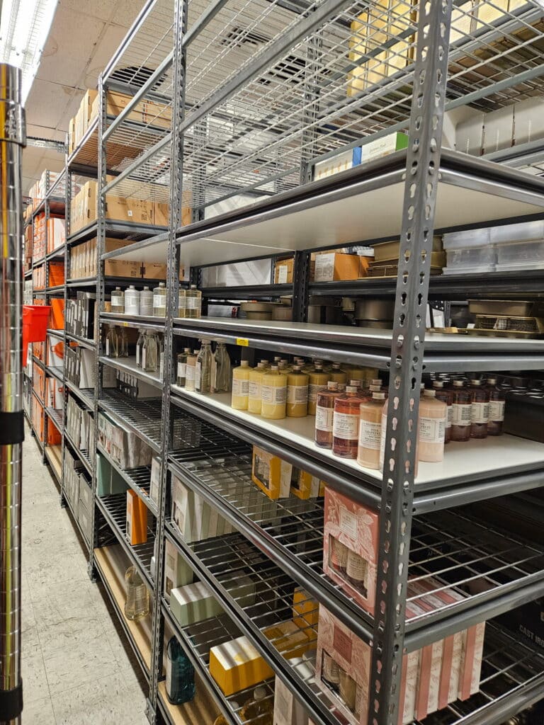 Rivet shelving storing home goods in a retail backroom