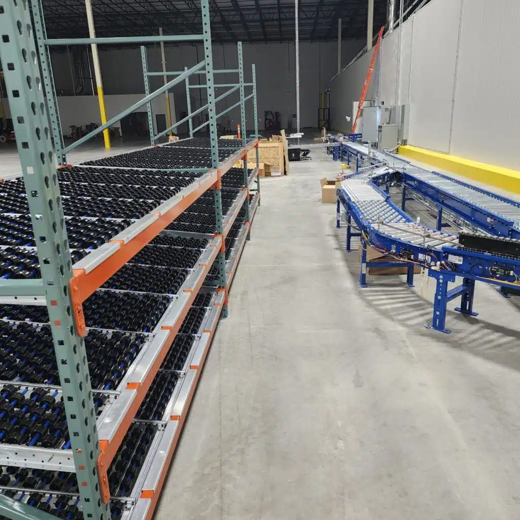 Carton flow racking next to conveyor system