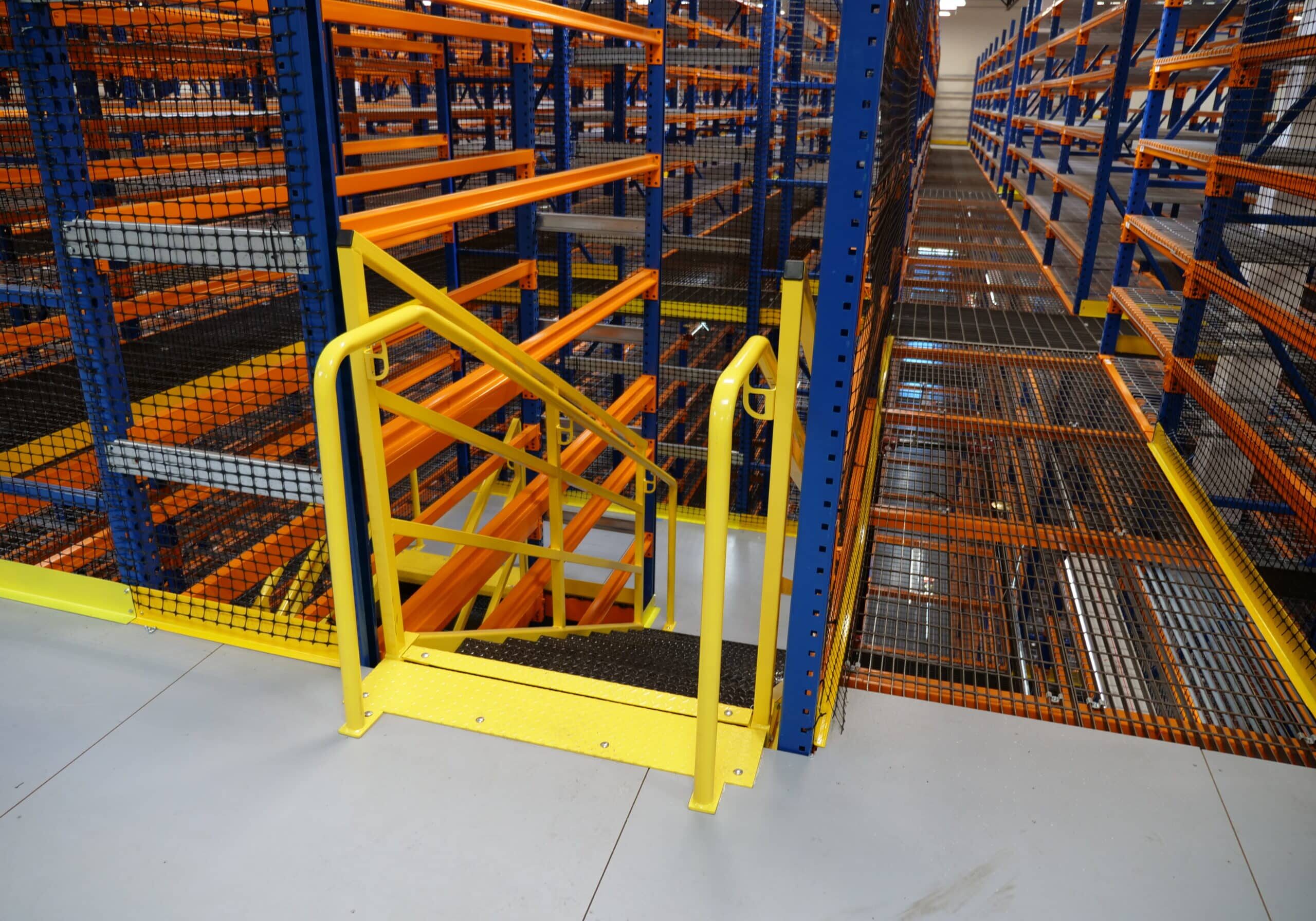 Staircase in a warehouse catwalk racking system